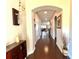 Long hallway with hardwood floors and views into living areas at 1831 Cameron Ct, New Port Richey, FL 34655