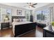 Main bedroom with king bed, hardwood floors, and large windows at 1831 Cameron Ct, New Port Richey, FL 34655