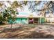 House with screened porch and a large backyard at 7256 Pinehurst Dr, Spring Hill, FL 34606