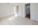 Bedroom with access to bathroom and tile floors at 7256 Pinehurst Dr, Spring Hill, FL 34606