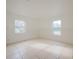 Bright bedroom with two windows and tile floors at 7256 Pinehurst Dr, Spring Hill, FL 34606