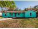 Charming teal house with a well-maintained lawn at 7256 Pinehurst Dr, Spring Hill, FL 34606