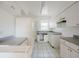 Kitchen features white cabinets and tile floors at 7256 Pinehurst Dr, Spring Hill, FL 34606