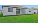 Home exterior with covered patio and grassy backyard at 13851 Richland Gulf Cir, Parrish, FL 34219