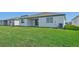 Newly built home with a spacious backyard and lush green lawn at 13851 Richland Gulf Cir, Parrish, FL 34219