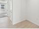 Bright hallway with wood-look tile flooring at 13851 Richland Gulf Cir, Parrish, FL 34219