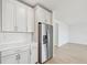 Kitchen features white cabinets, stainless steel refrigerator, and quartz countertops at 13851 Richland Gulf Cir, Parrish, FL 34219