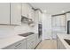 Modern kitchen with white cabinets, quartz countertops and stainless steel appliances at 13851 Richland Gulf Cir, Parrish, FL 34219