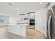 Modern kitchen with white cabinets, quartz countertops, and stainless steel appliances at 13851 Richland Gulf Cir, Parrish, FL 34219