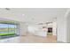 Open kitchen with island, white cabinets, and stainless steel appliances at 13851 Richland Gulf Cir, Parrish, FL 34219