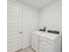 Bright laundry room features washer, dryer, and built-in shelving at 13851 Richland Gulf Cir, Parrish, FL 34219