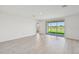 Living room with sliding doors opening to a view of a lake at 13851 Richland Gulf Cir, Parrish, FL 34219