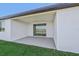 Covered patio with sliding glass doors and grassy area at 13851 Richland Gulf Cir, Parrish, FL 34219