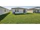 House backyard with green lawn and sliding door at 14036 Crutchfield Ct, Parrish, FL 34219