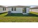 House backyard with green lawn and sliding door at 14036 Crutchfield Ct, Parrish, FL 34219