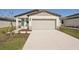 Newly constructed home with attached garage and landscaped front yard at 14036 Crutchfield Ct, Parrish, FL 34219