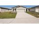 House exterior showcasing a light green door and a landscaped yard at 14036 Crutchfield Ct, Parrish, FL 34219