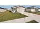 House exterior with a light-colored garage door and neatly kept lawn at 14036 Crutchfield Ct, Parrish, FL 34219