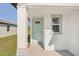 Light teal front door with sidelight window and stone accents at 14036 Crutchfield Ct, Parrish, FL 34219