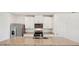 Modern kitchen with granite countertops, stainless steel appliances, and white cabinets at 14036 Crutchfield Ct, Parrish, FL 34219