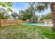 Spacious backyard with a large pool and wooden fence at 2514 Beach S Blvd, Gulfport, FL 33707