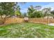Landscaped backyard with a wooden fence and a grilling area at 2514 Beach S Blvd, Gulfport, FL 33707