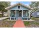 Charming bungalow with a light blue facade, front porch, and landscaped yard at 2514 Beach S Blvd, Gulfport, FL 33707