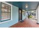 Quaint front porch with terracotta tile flooring at 2514 Beach S Blvd, Gulfport, FL 33707
