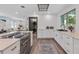Modern kitchen with white cabinets and laundry area at 2514 Beach S Blvd, Gulfport, FL 33707