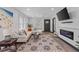 Bright and airy living room with L-shaped sofa, fireplace, and large TV at 2514 Beach S Blvd, Gulfport, FL 33707