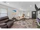 Open living room with L-shaped sofa, fireplace and large windows at 2514 Beach S Blvd, Gulfport, FL 33707