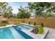 Inviting pool and spa with a modern design and wooden fence at 2514 Beach S Blvd, Gulfport, FL 33707