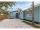 Gravel driveway and side yard with wooden fence at 2514 Beach S Blvd, Gulfport, FL 33707