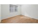 Spacious bedroom with wood-look tile flooring and window at 13855 Richland Gulf Cir, Parrish, FL 34219