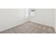 Bright bedroom with carpeted floor, window, and door at 13855 Richland Gulf Cir, Parrish, FL 34219