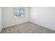 Spacious bedroom with grey carpet and window at 13855 Richland Gulf Cir, Parrish, FL 34219