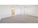 Spacious bedroom with two doors and carpeted floor at 13855 Richland Gulf Cir, Parrish, FL 34219