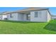 Rear view of house showing patio and grassy yard at 13855 Richland Gulf Cir, Parrish, FL 34219