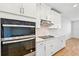 Modern kitchen with double oven and white cabinets at 13855 Richland Gulf Cir, Parrish, FL 34219