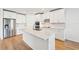 Modern kitchen with island, stainless steel appliances, and white cabinets at 13855 Richland Gulf Cir, Parrish, FL 34219