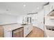 Modern kitchen with island, stainless steel appliances, and white cabinets at 13855 Richland Gulf Cir, Parrish, FL 34219