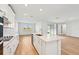 Modern kitchen with island, stainless steel appliances, and white cabinets at 13855 Richland Gulf Cir, Parrish, FL 34219