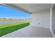 Covered patio overlooking a serene lake at 13855 Richland Gulf Cir, Parrish, FL 34219
