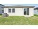 Backyard with grassy lawn and sliding glass door at 14037 Crutchfield Ct, Parrish, FL 34219