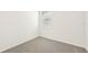 Simple bedroom with grey carpet and a window at 14037 Crutchfield Ct, Parrish, FL 34219