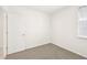 Well-lit bedroom featuring grey carpet and a door at 14037 Crutchfield Ct, Parrish, FL 34219