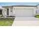 Modern one-story home with attached garage and landscaping at 14037 Crutchfield Ct, Parrish, FL 34219