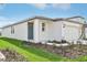 White one-story house with gray door and landscaping at 14037 Crutchfield Ct, Parrish, FL 34219