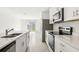 Modern kitchen with stainless steel appliances and white cabinets at 14037 Crutchfield Ct, Parrish, FL 34219