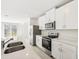 Modern kitchen with stainless steel appliances and white cabinets at 14037 Crutchfield Ct, Parrish, FL 34219